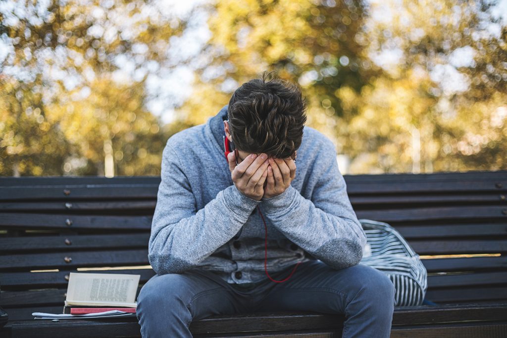 Teenager has a headache because a lot of learning